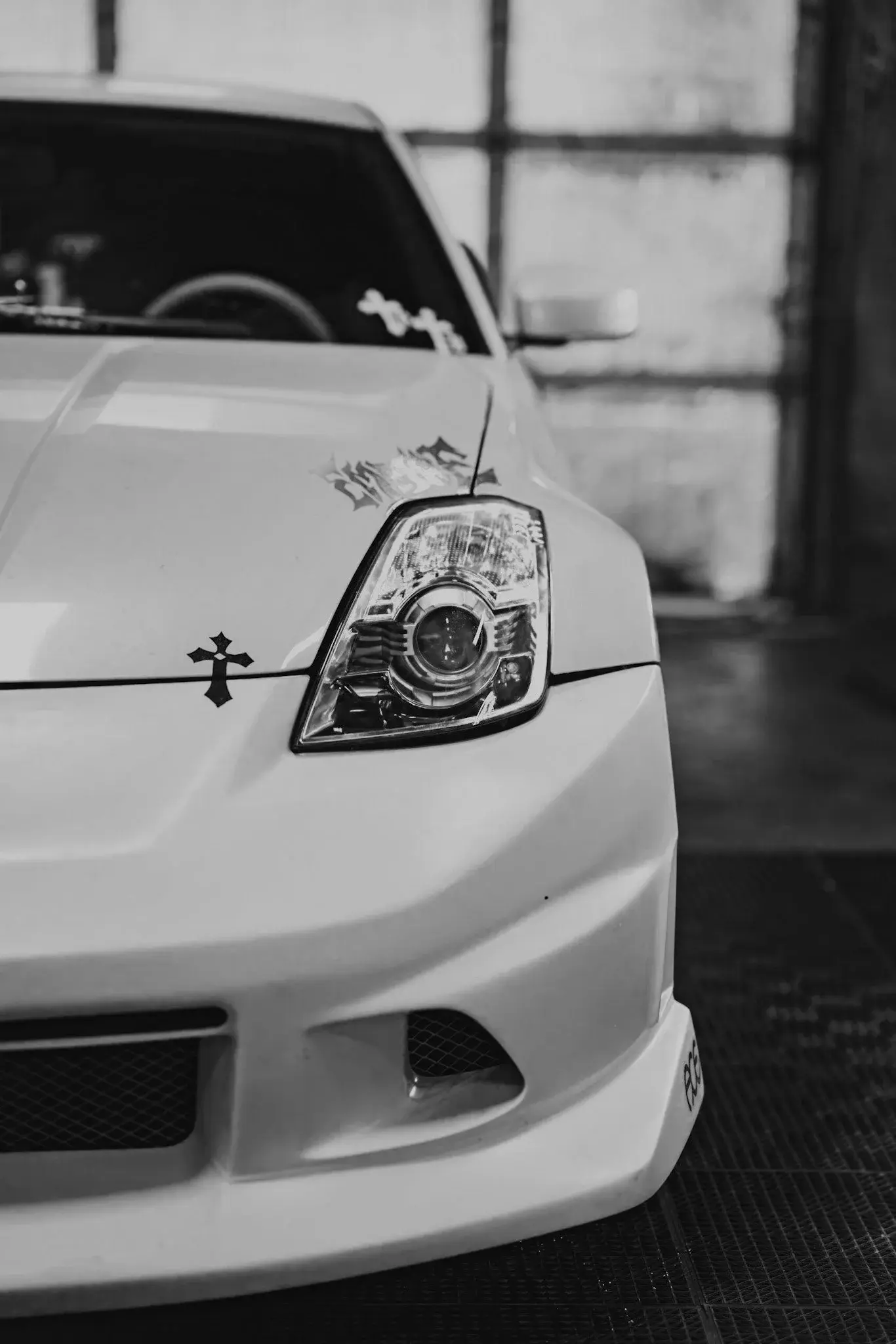 Front of a white Nissan 350Z, black and white
