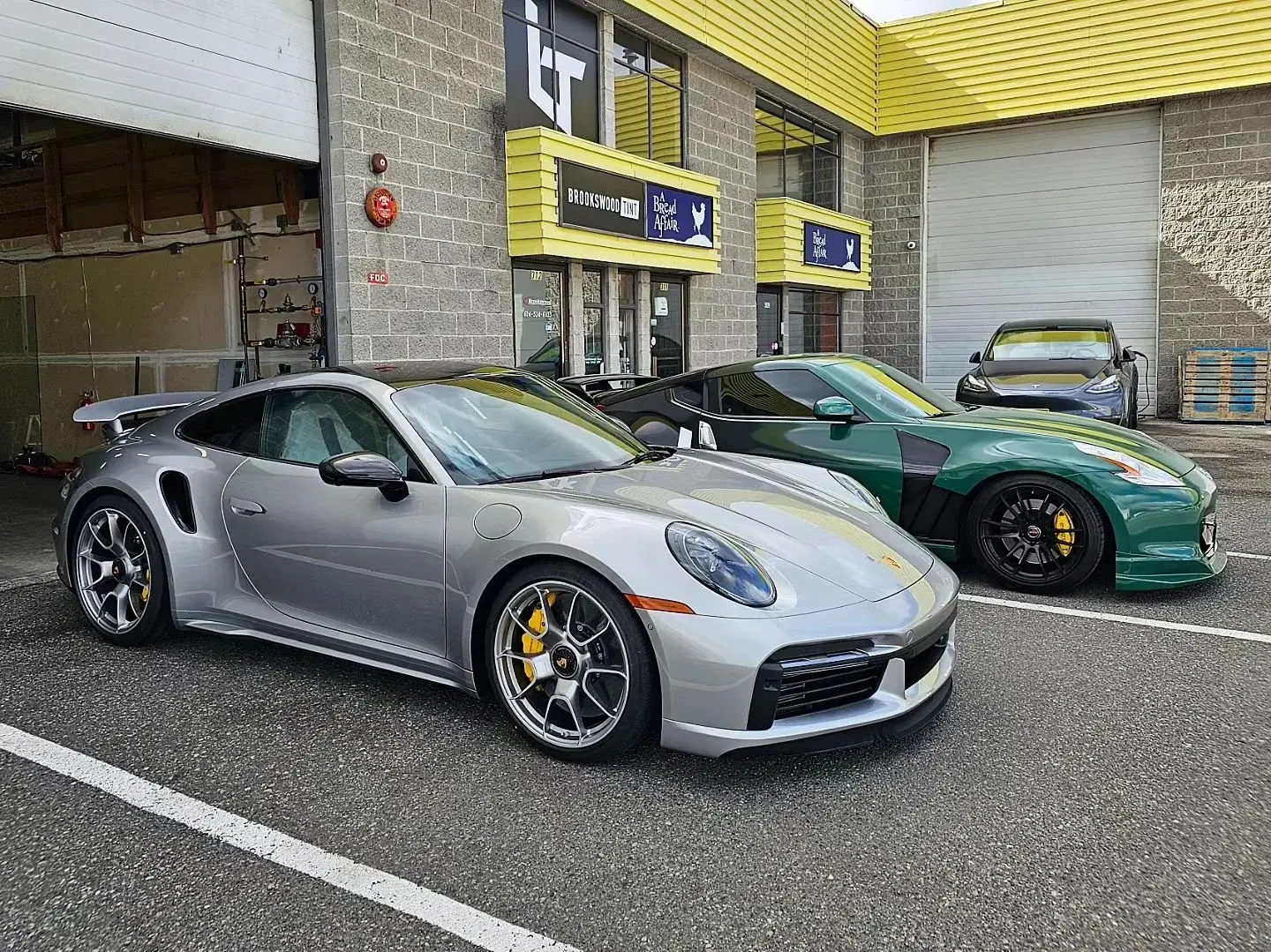 Silver Porsche 911 Turbo S parked outside the Brookswood Tint storefront on the Langley Bypass