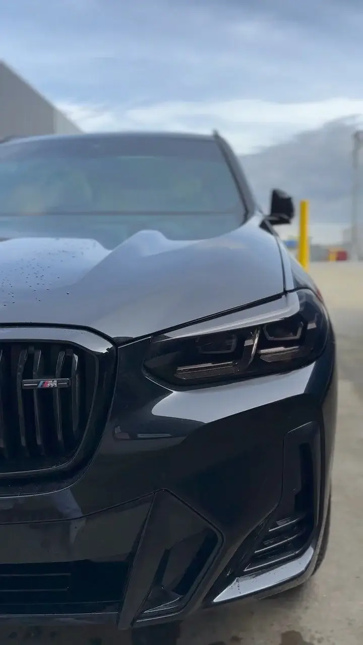 Front of a black BMW X5 M with blacked-out grille