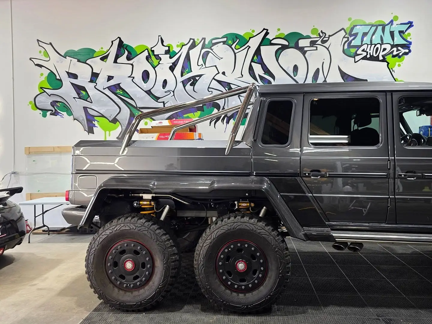 Mercedes G63 6x6 inside the shop against the graffiti wall
