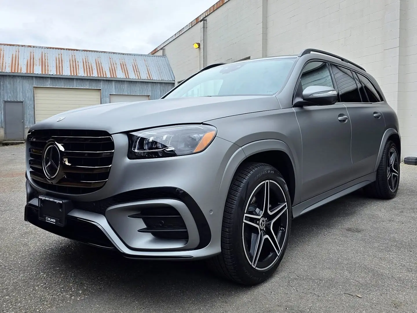 Mercedes GLS in a matte metallic gunmetal vinyl wrap, front three-quarter