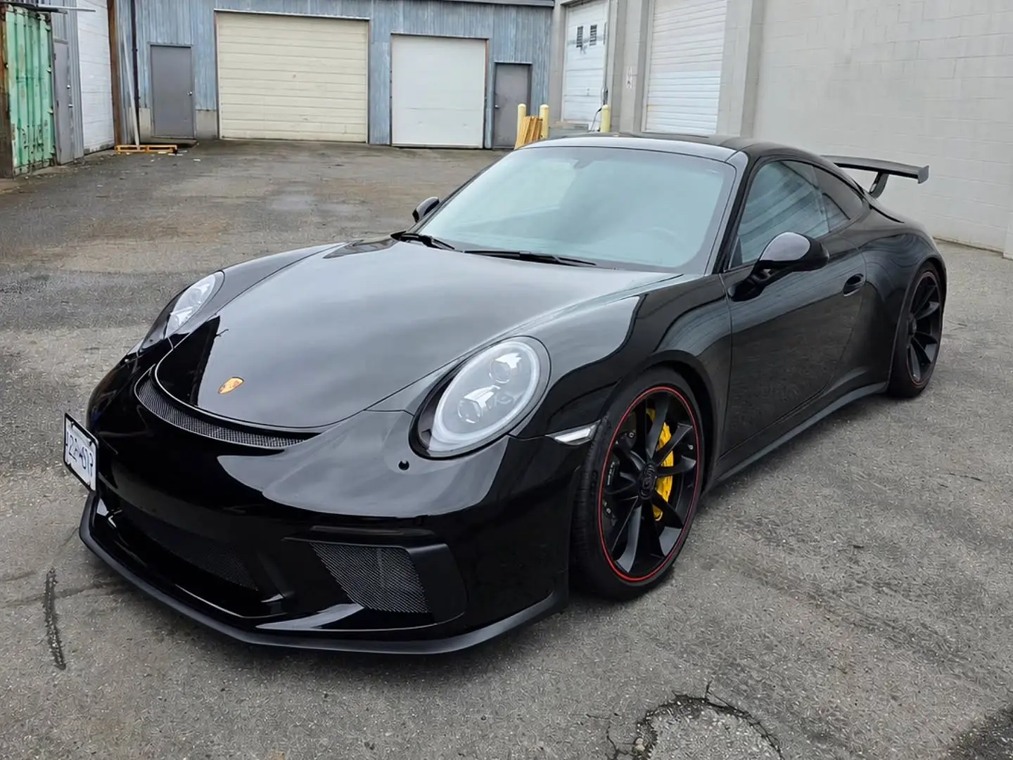 Black Porsche 911 GT3 991.2 outside the shop, all windows tinted