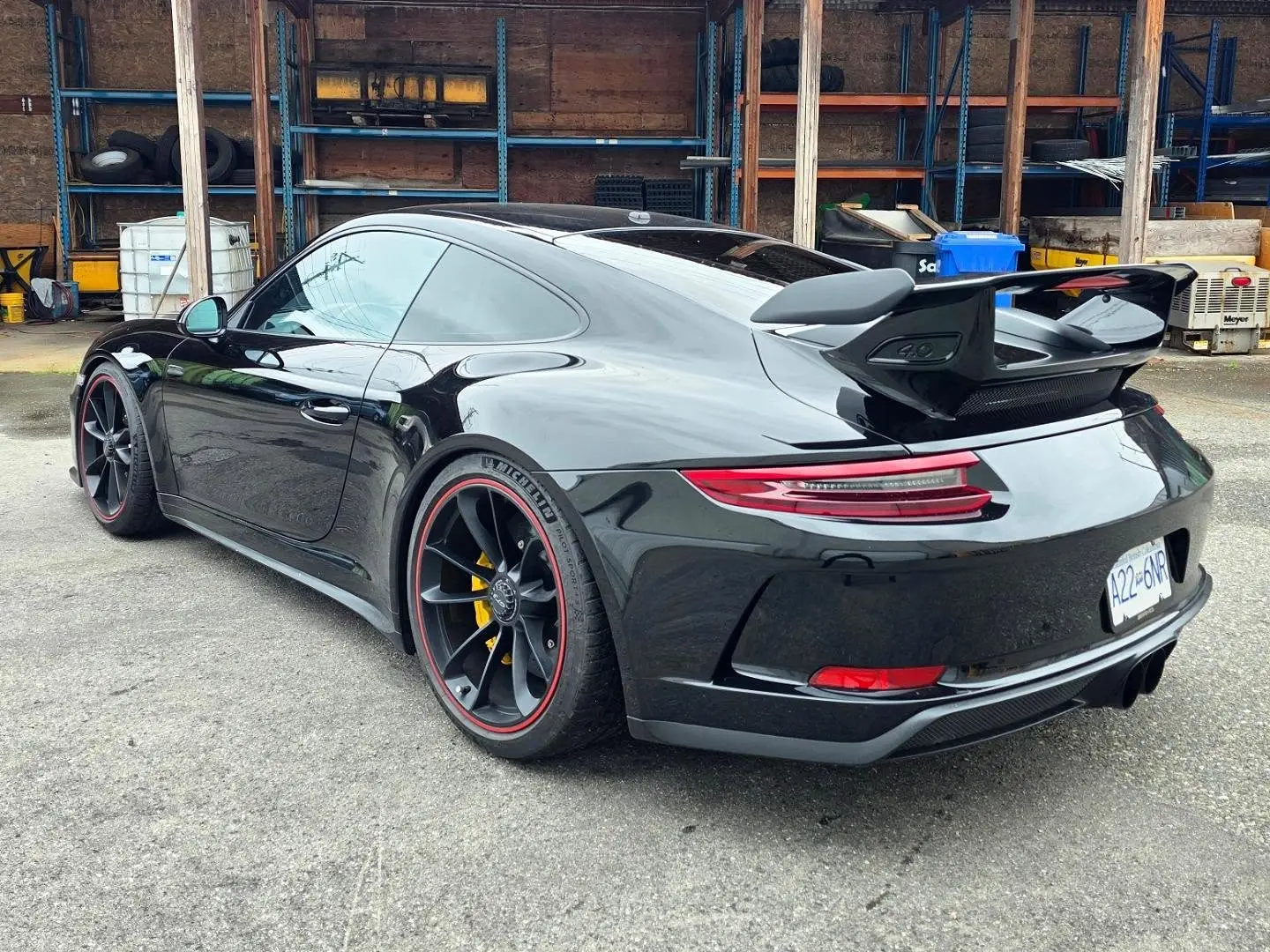 Rear three-quarter of a black Porsche 911 GT3 with its wing