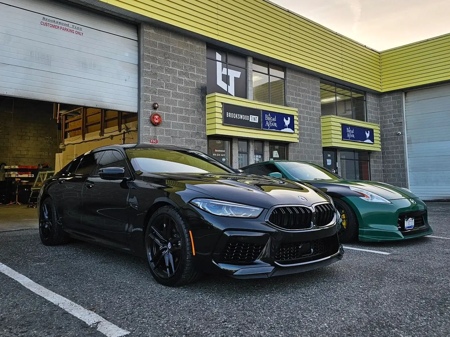 Black BMW M8 Competition with chrome delete parked outside the shop