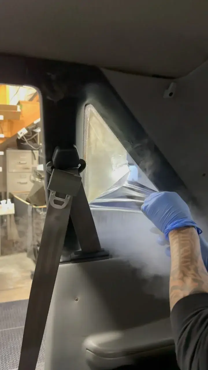 Rear window film being fitted inside a car