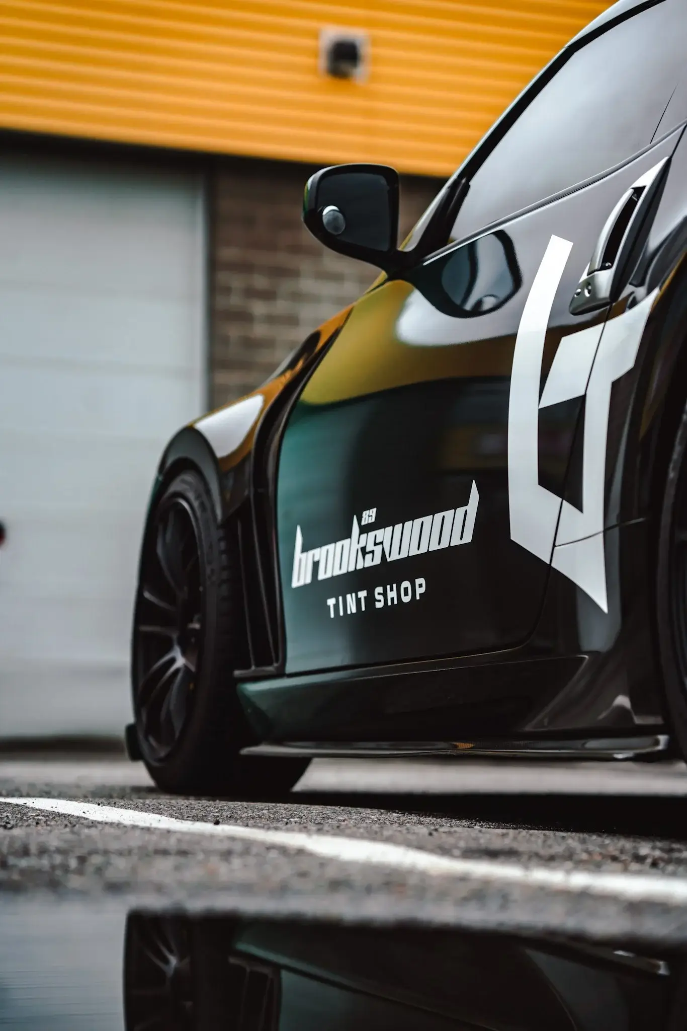 Close-up of the Brookswood Tint Shop livery on a black Nissan 370Z