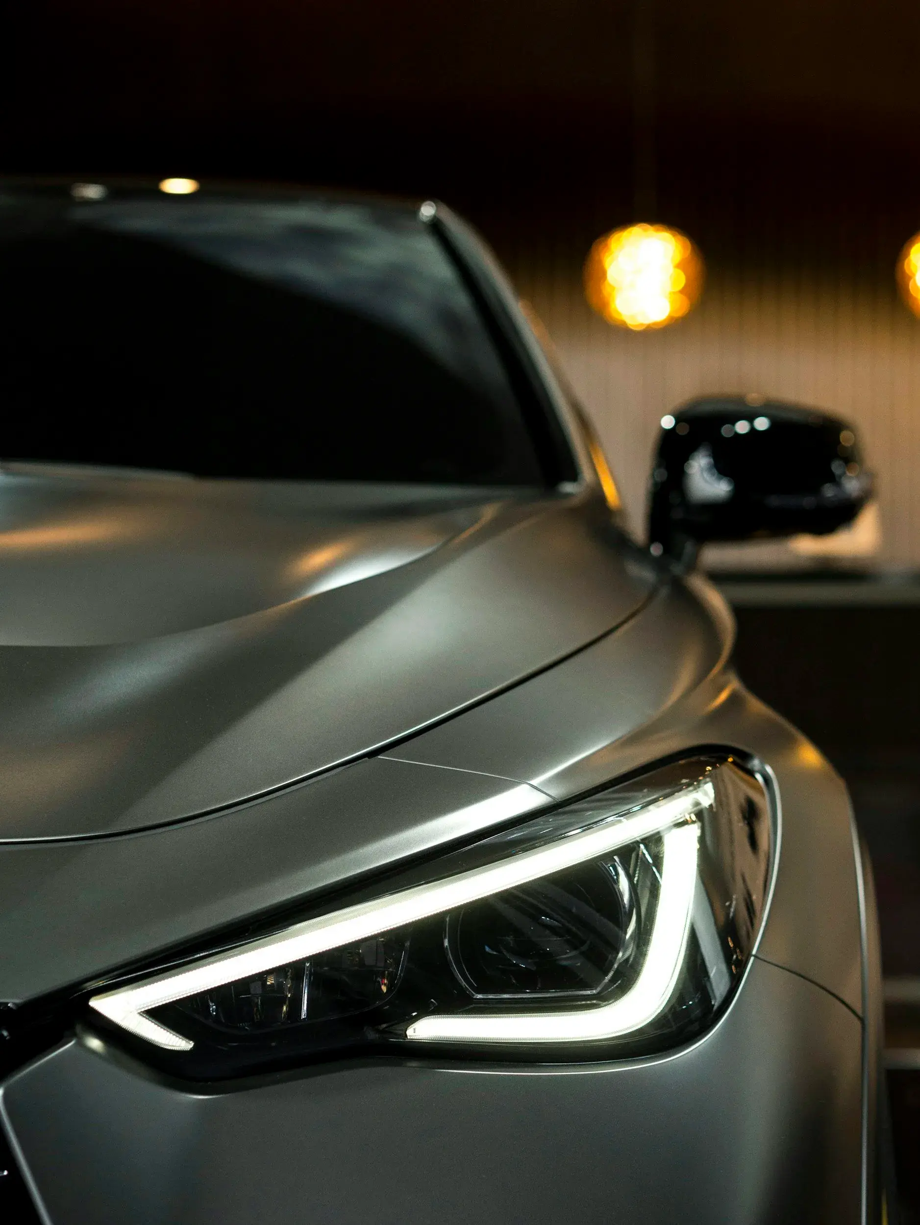 Close-up of a grey car's crisp, clear headlight lens