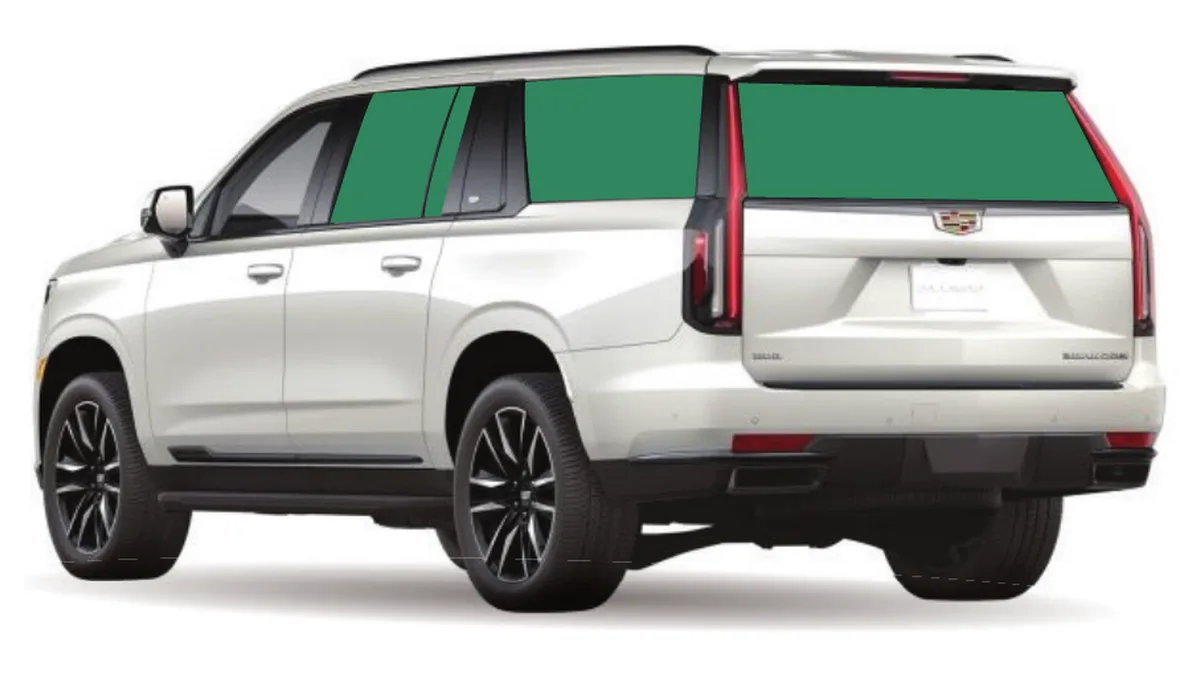 White full-size SUV seen from behind with every window behind the front doors shaded to show the tinted glass